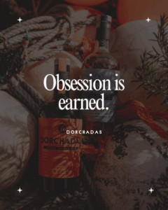 Quote: obsession is earned Background: Dorchadas Amber Spiced Rum and Dorchadas Washed Ashore bottles basking in the sun on a beach next to some bouys